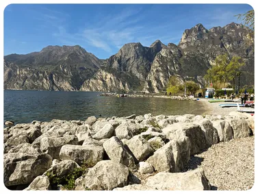 Deep blue waters and olive groves of Lake Garda - Explore photos of Italy’s largest Mediterranean-Alpine lake.